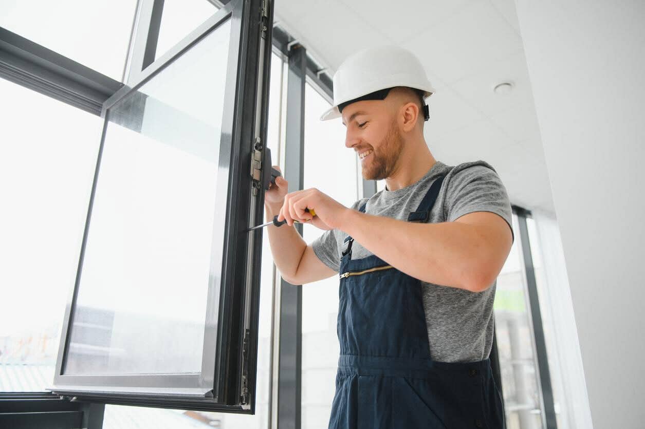 Man making impact windows secure.