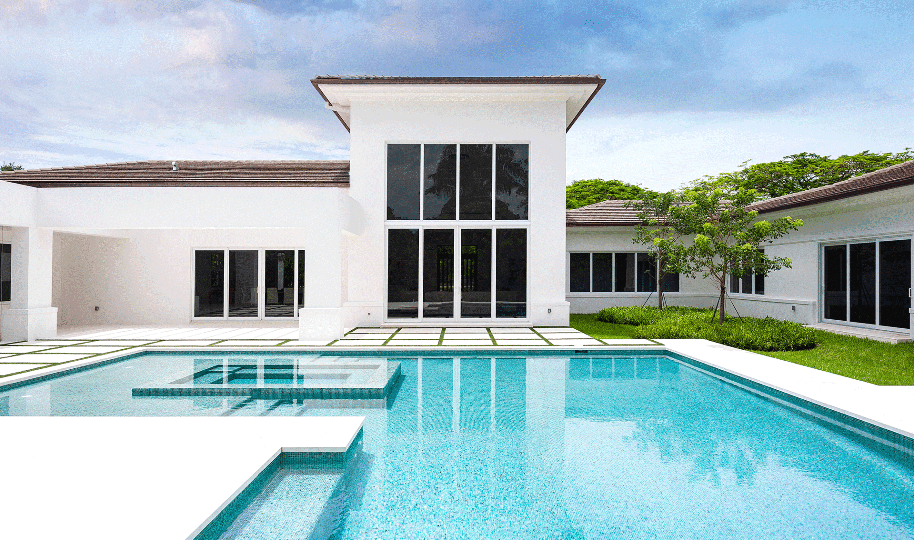 New patio doors for spring: Home exterior with outdoor pool.